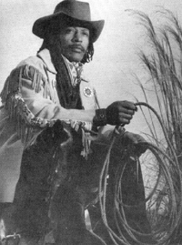 Miles Dean in riding gear with a lasso
